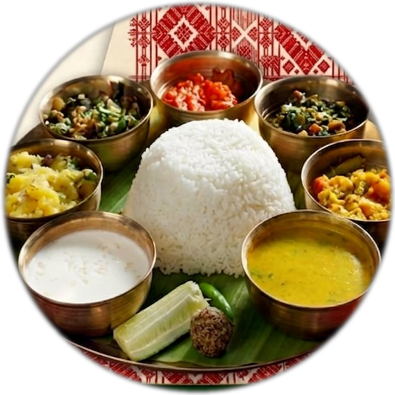 Authentic Assamese thali — rice, dal, curries served in brass bowls on banana leaf